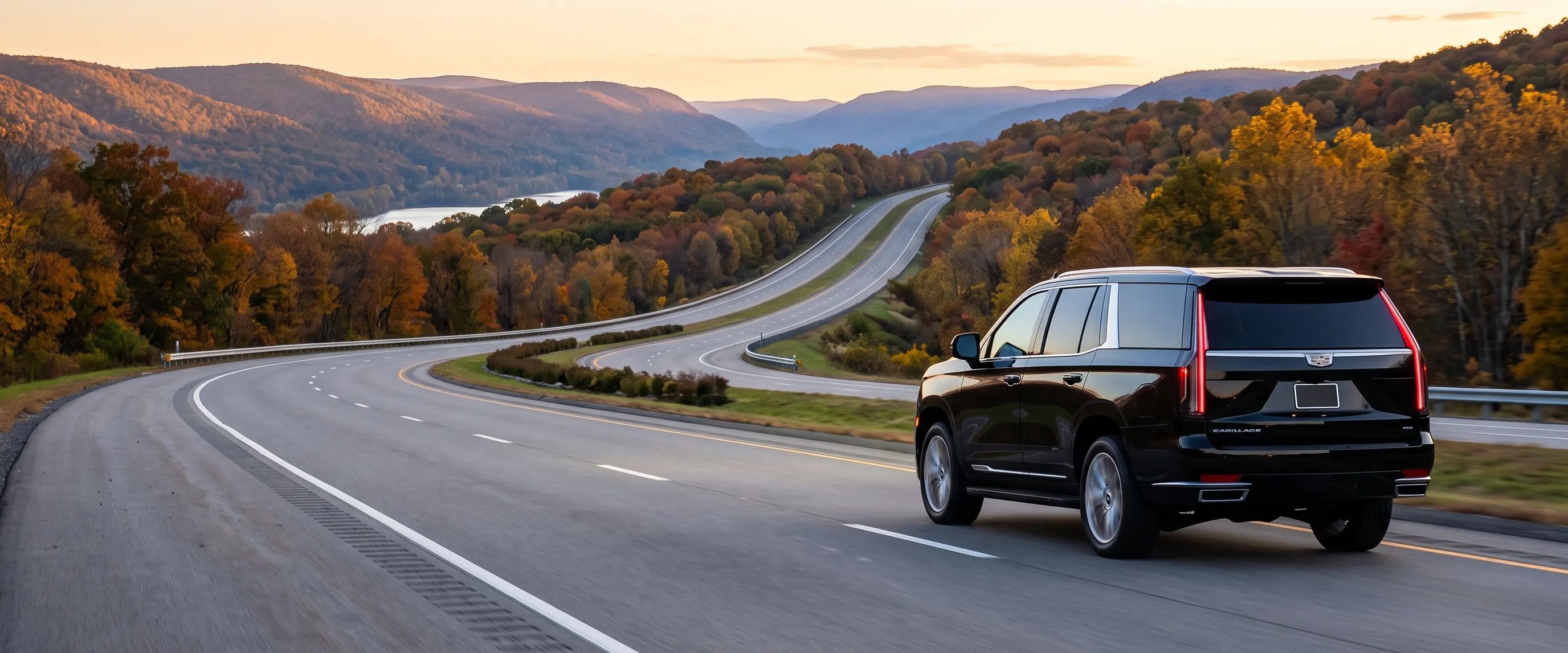 Black Cadillac Escalade on an open highway at dusk, leaving the New York metro area